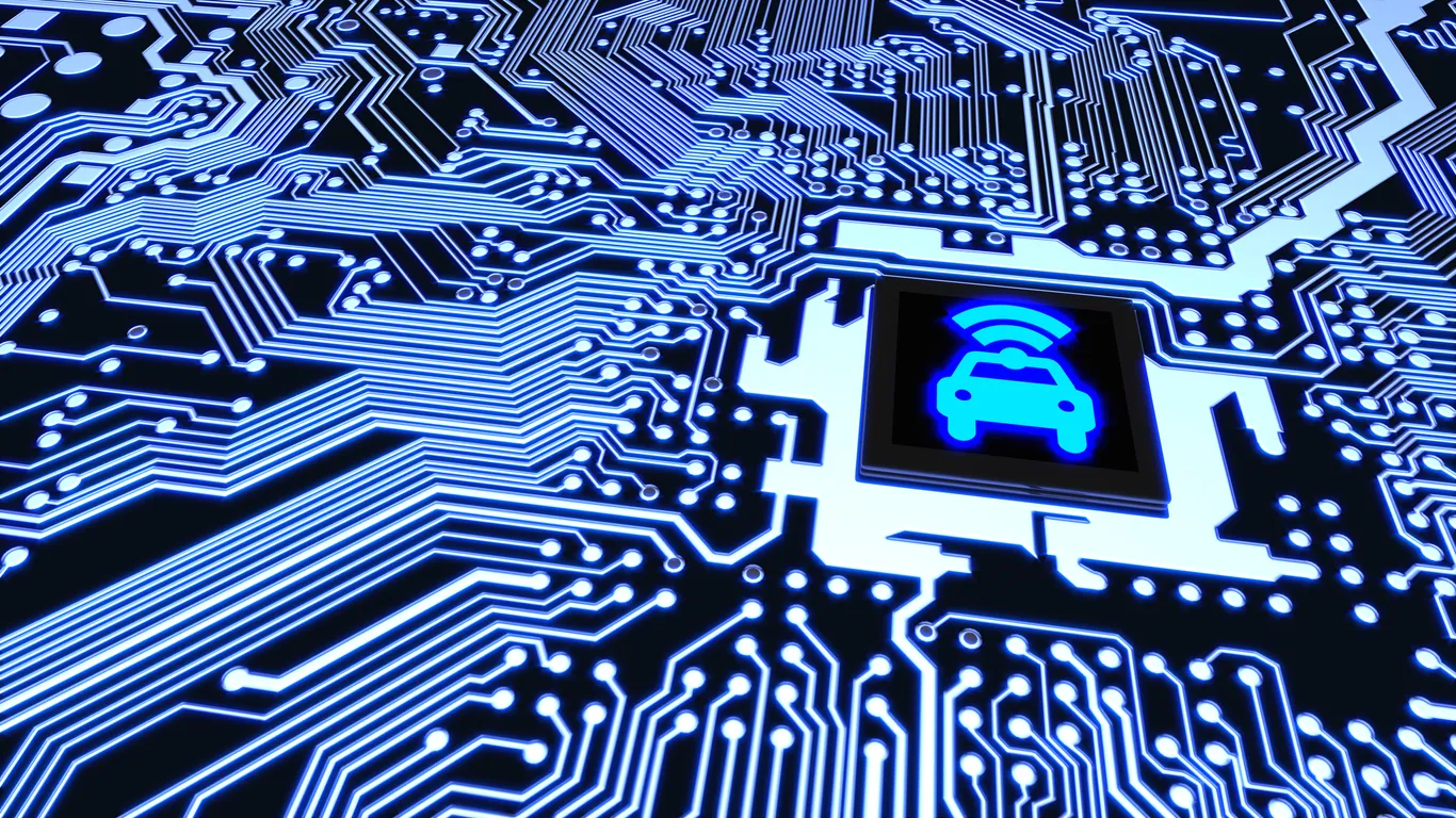 Close-up of a circuit board with blue light highlighting a symbol of a car, suggesting connectivity or smart vehicle technology.